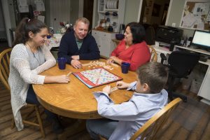 Mike Noland family enjoying scrabble game. (image)
